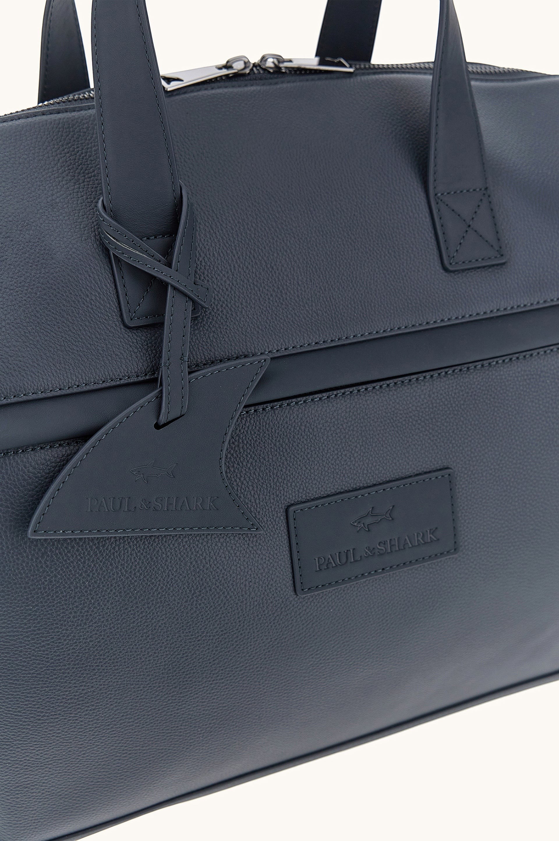 Button Down SF navy tumbled leather holdall bag with shark fin detail and handles. Includes shoulder strap.