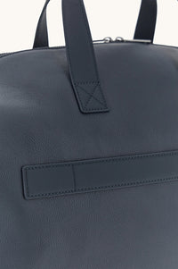 Button Down SF navy tumbled leather holdall bag with shark fin detailing and handles. Includes shoulder strap.