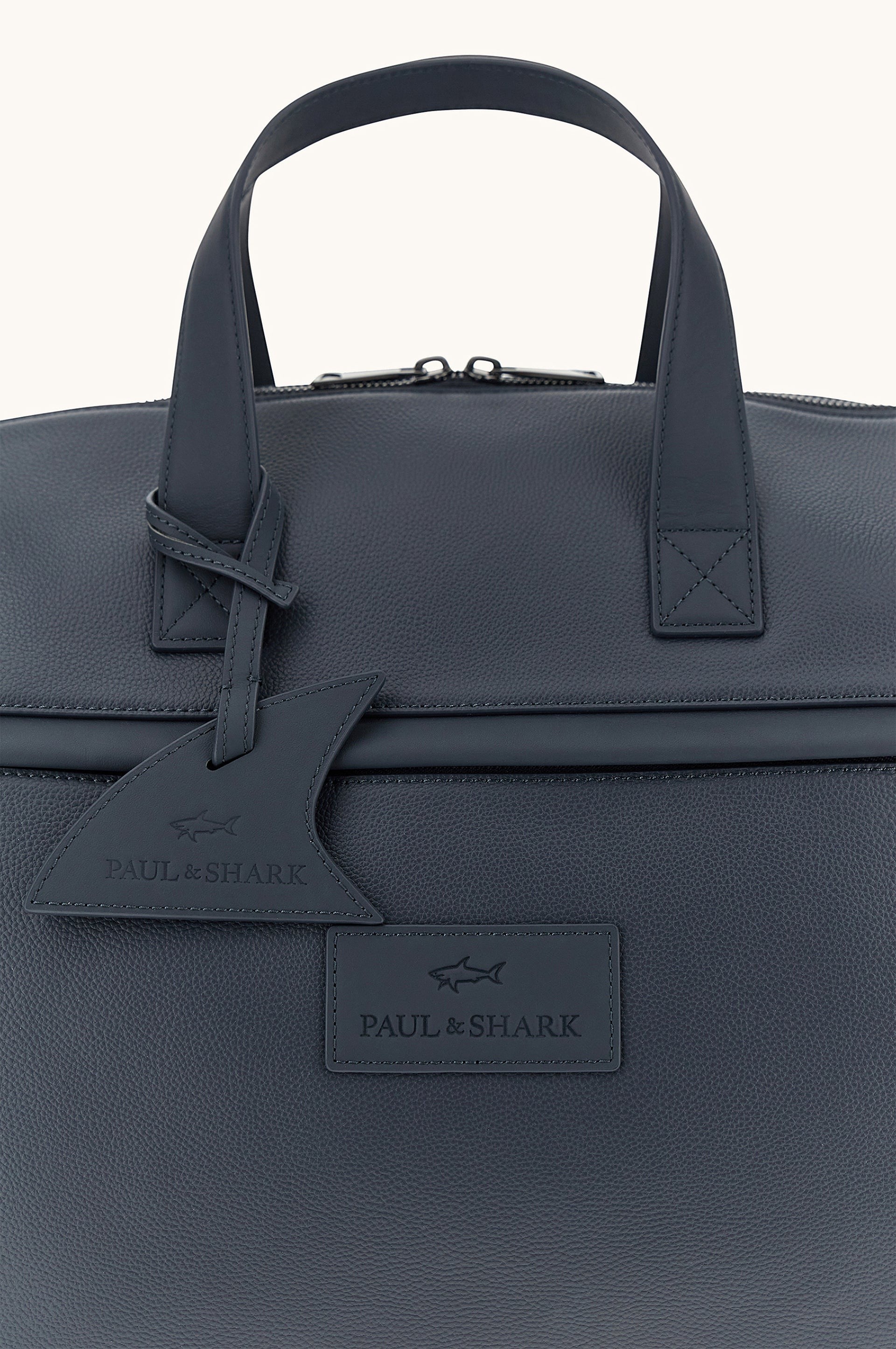 Button Down SF navy tumbled leather holdall bag with shark fin detail and handles. Includes shoulder strap.