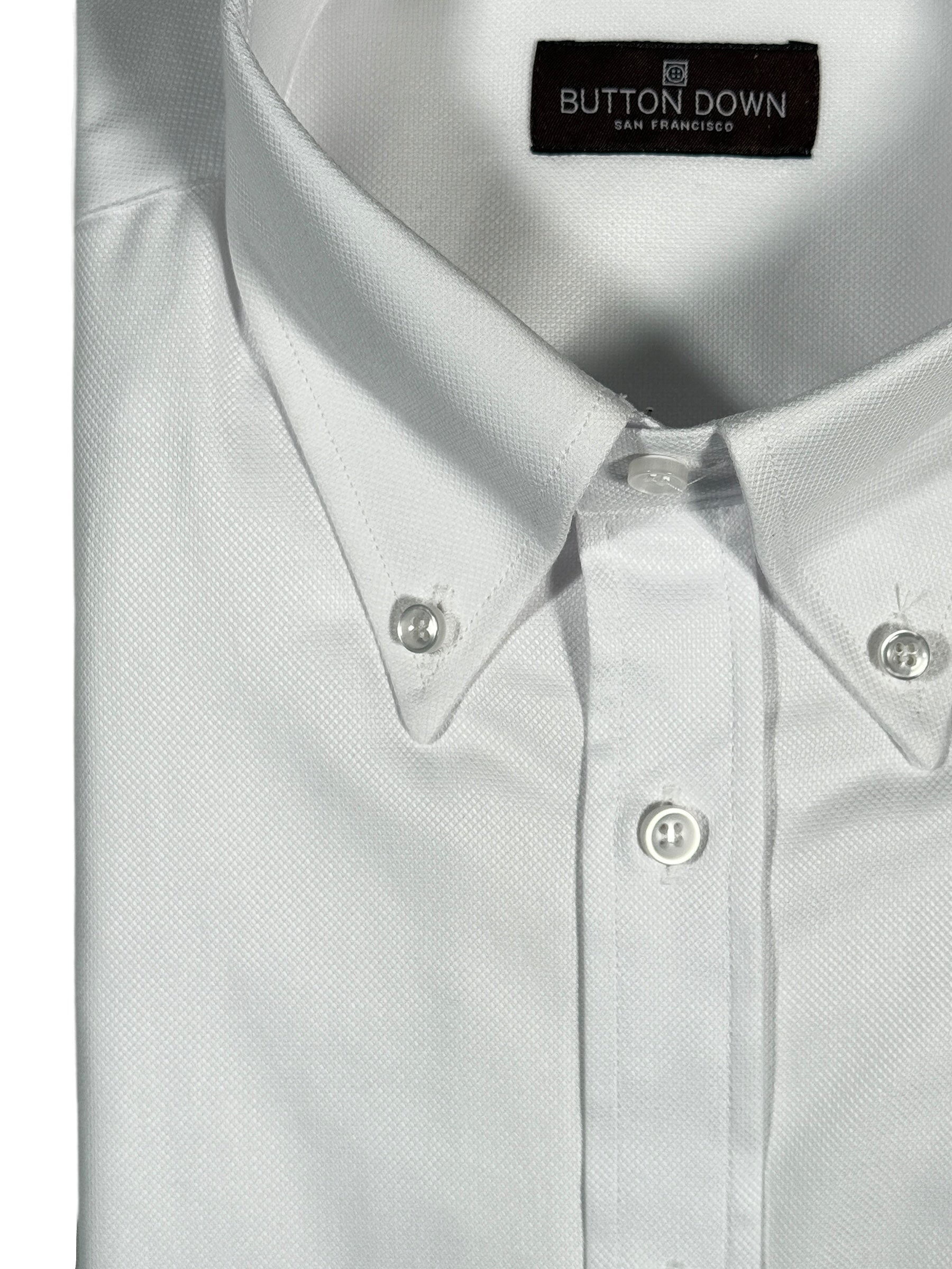 White button-up shirt with collar and buttons, featuring 'Button Down San Francisco' label.