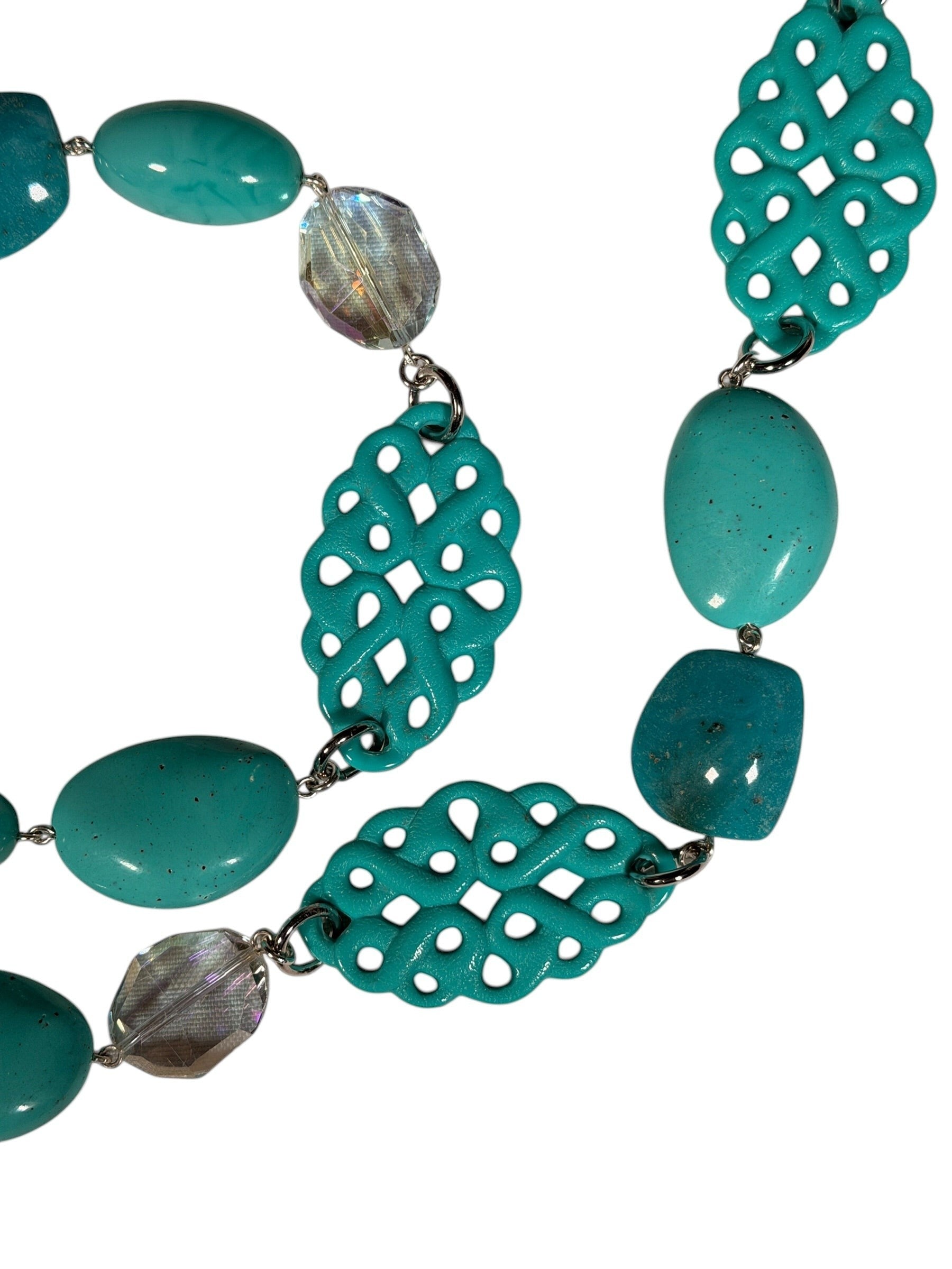 Button Down SF turquoise resin statement necklace with intricate cut-out details and polished beads.