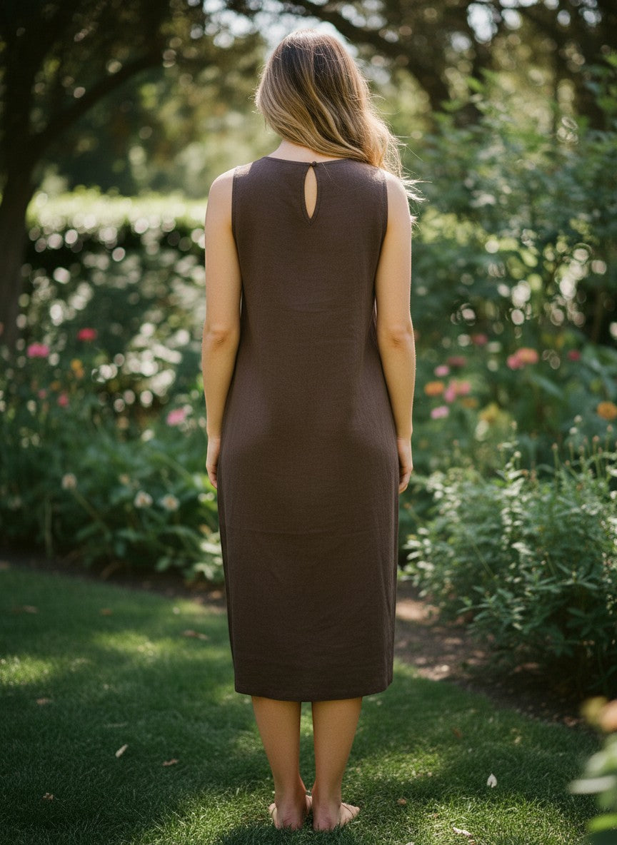 Button Down SF brown linen sleeveless midi dress with round neckline and keyhole back detail, worn by a woman in a garden.
