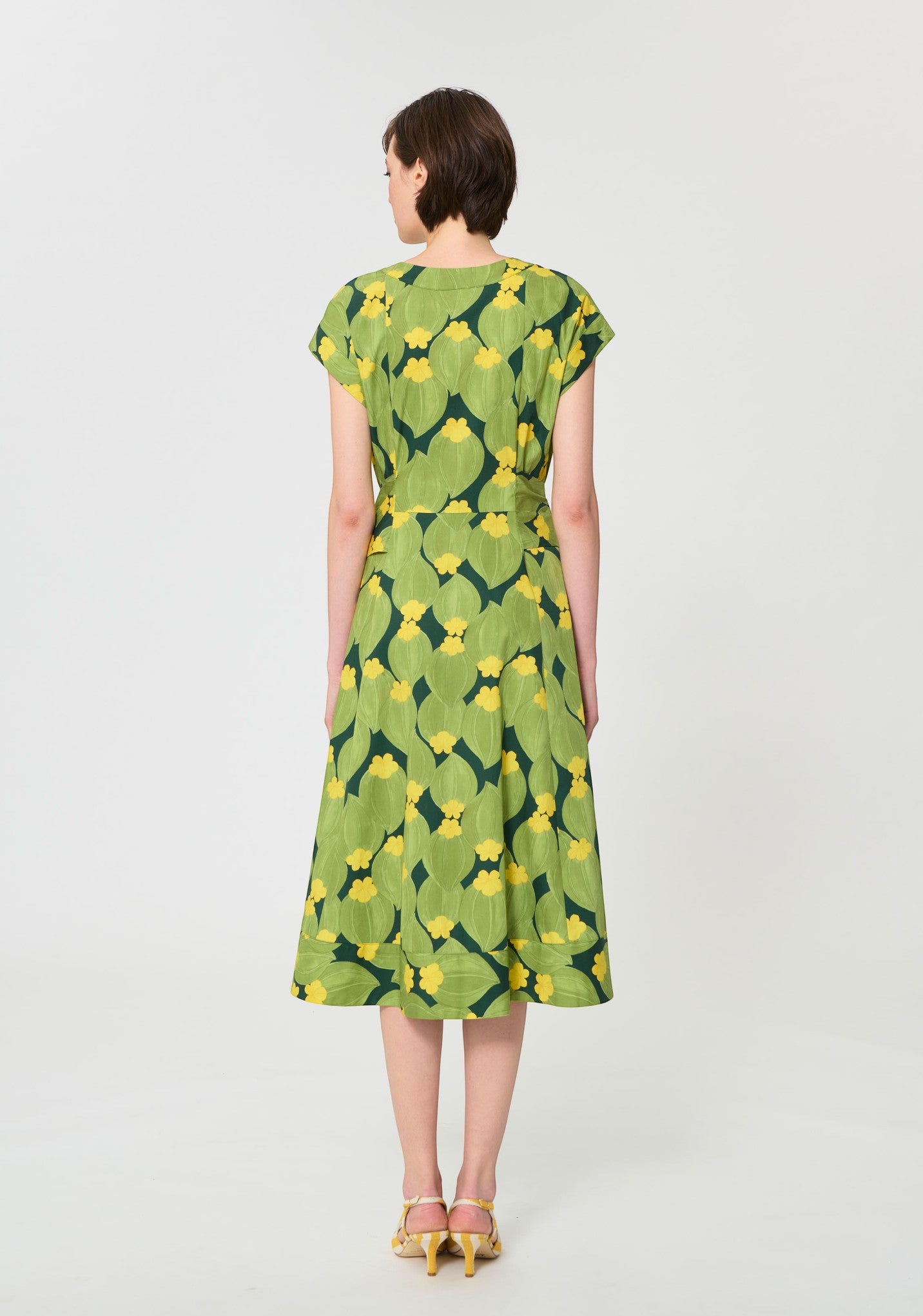 Button Down SF green and yellow botanical print midi dress with V-neck, short sleeves, and self-tie waist. 100% cotton.