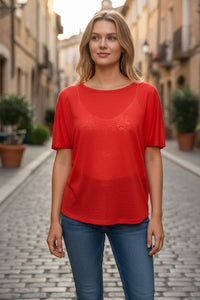 Button Down SF orange 100% linen short sleeve tee with a relaxed fit, worn by a model on a cobblestone street.