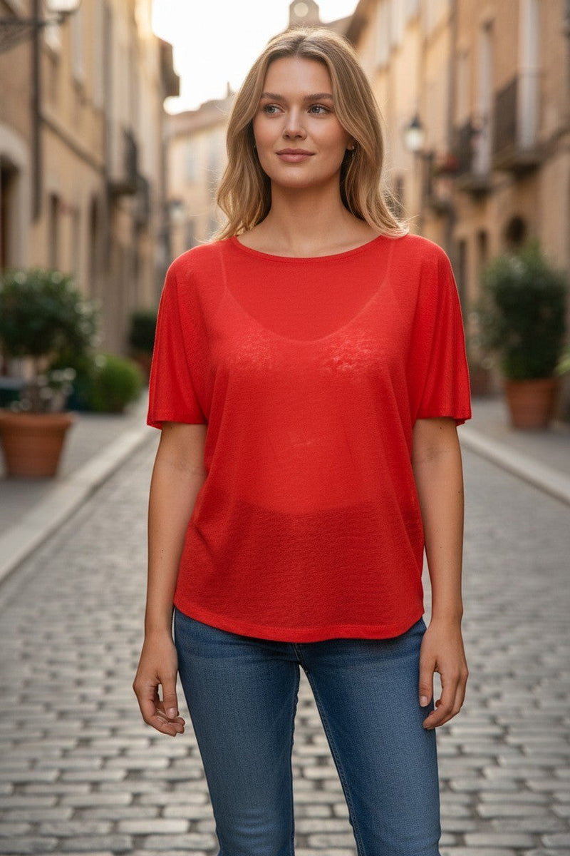 Button Down SF orange 100% linen short sleeve tee with a relaxed fit, worn by a model on a cobblestone street.