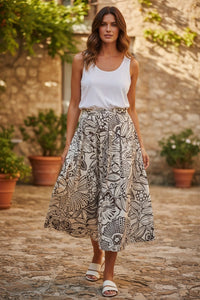 Button Down SF OUI floral print midi skirt in white and brown cotton, worn by a model outdoors.