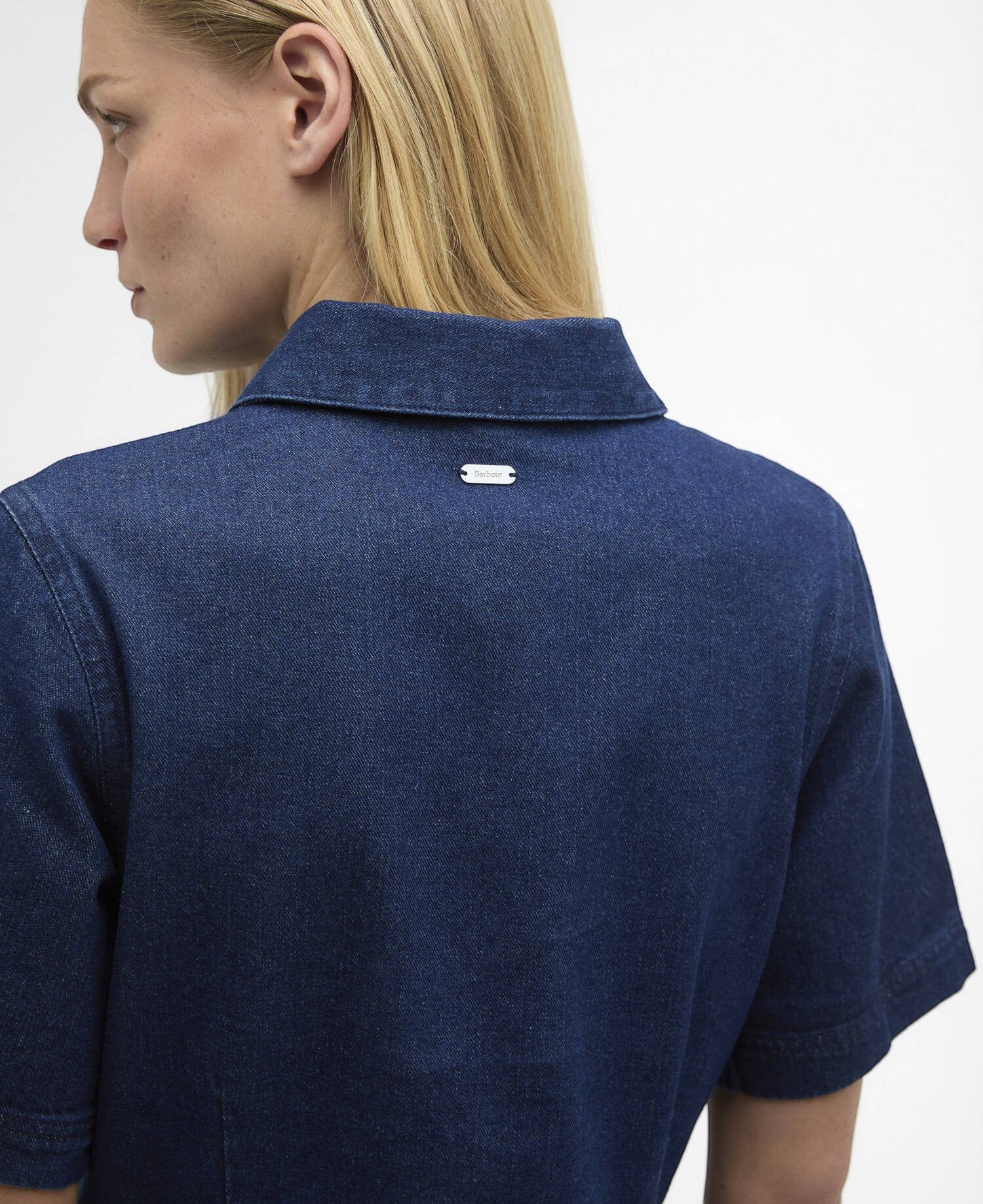 Button Down SF rinse wash denim mini dress with short sleeves and a Barbour logo detail on the back collar.