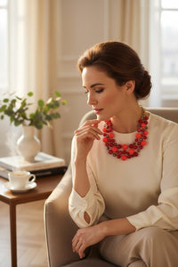 Button Down SF necklace with three strands of mixed pink and red resin beads and crystal accents.