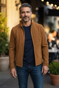 Button Down SF tobacco brown perforated suede driver jacket on a man wearing a navy t-shirt and jeans.