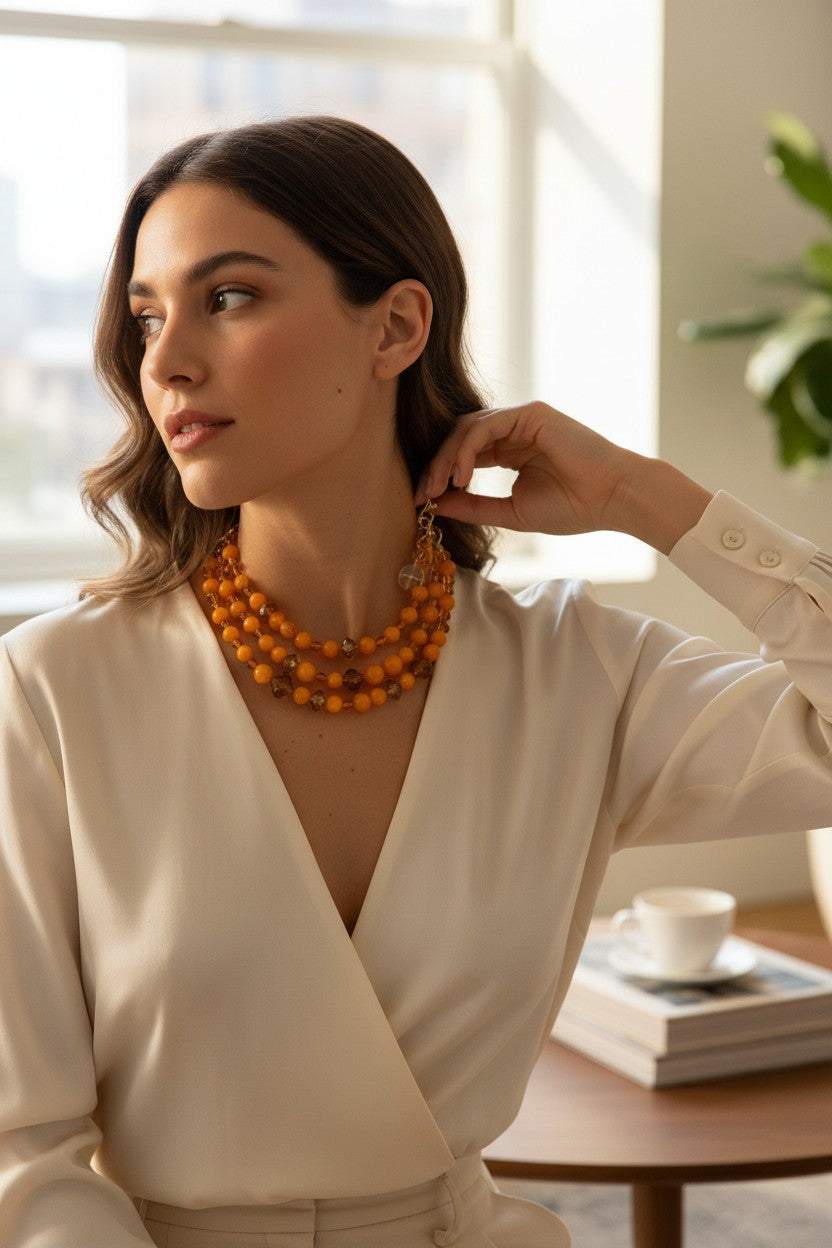 Button Down SF triple strand necklace with mixed yellow resin beads and faceted crystals, adjustable length.